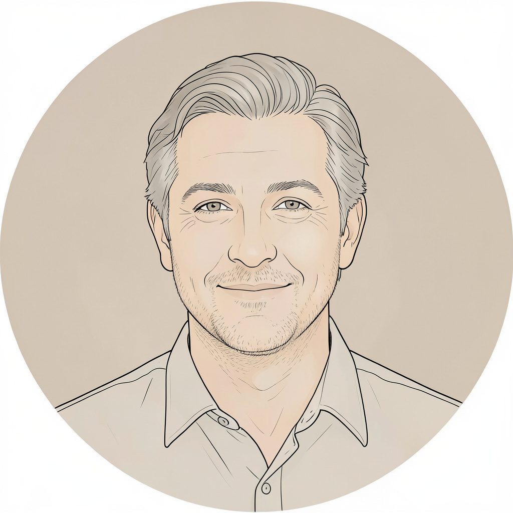 A warm, softly lit circular portrait of a man with graying hair and a gentle smile, against a muted neutral background